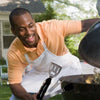 Man enjoying sunny day at the grill with the Barbecue 5 in 1 Multifunction Grill Utensil Stainless steel, food-grade, dishwasher safe. Great gift idea for men, an excellent stocking stuffer!