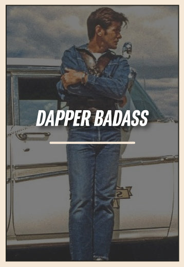 Person in a denim outfit standing next to a vintage car with 'Dapper Badass' text overlay.